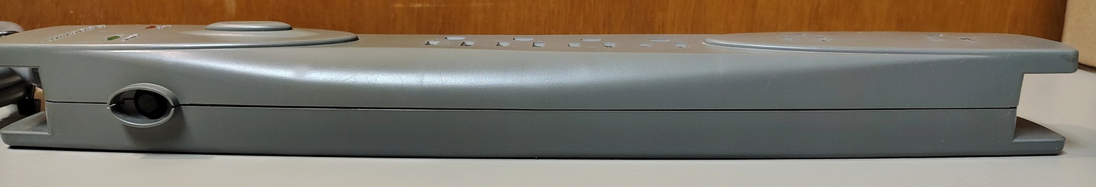 Side profile showing the push-button switching mechanism incorporated into the enclosure.