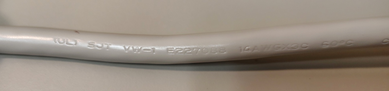 Power-cord markings showing SJT construction, conductor size, and approval information.