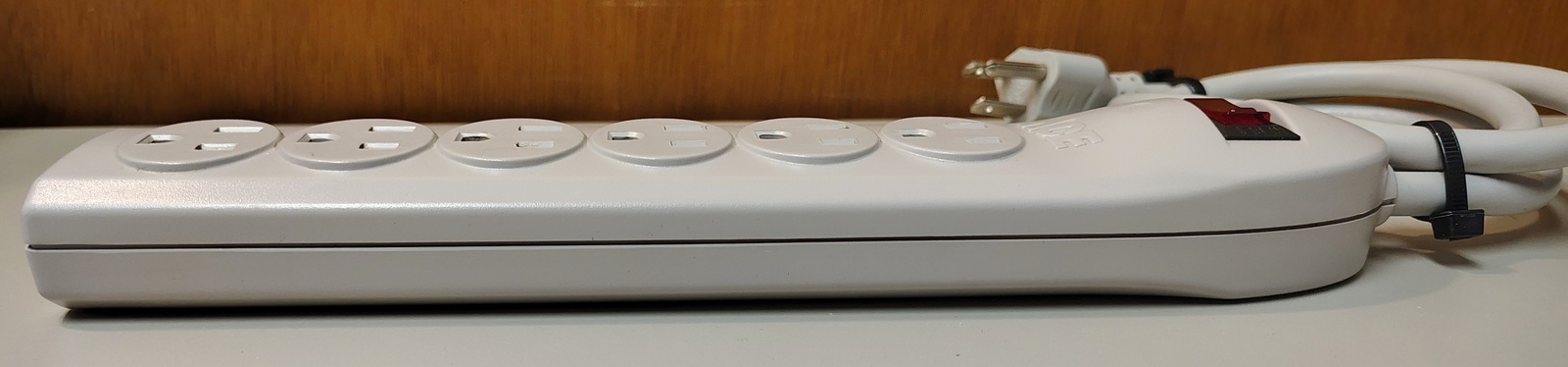 Left-side profile showing the tapered enclosure shape and outlet arrangement.