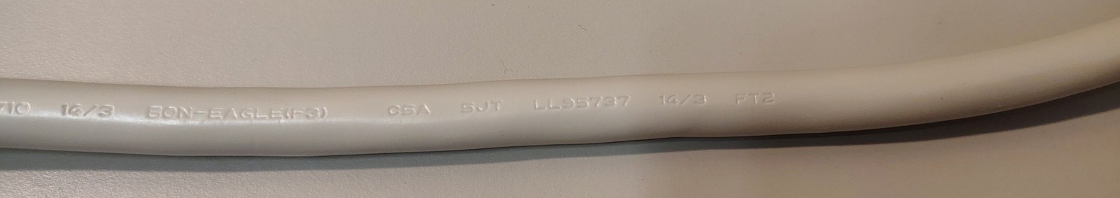 Additional power-cord markings showing conductor size, certification markings, and manufacturer information.