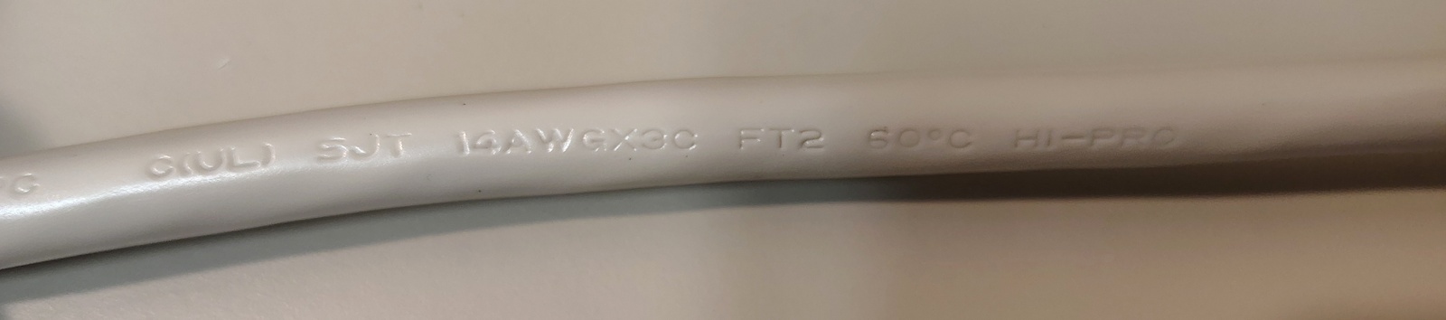 Additional power-cord markings showing conductor size, flame rating, temperature rating, and manufacturer identification.