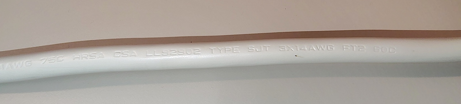 Additional power-cord markings showing CSA file number LL52902, FT2 flame rating, and conductor specifications.
