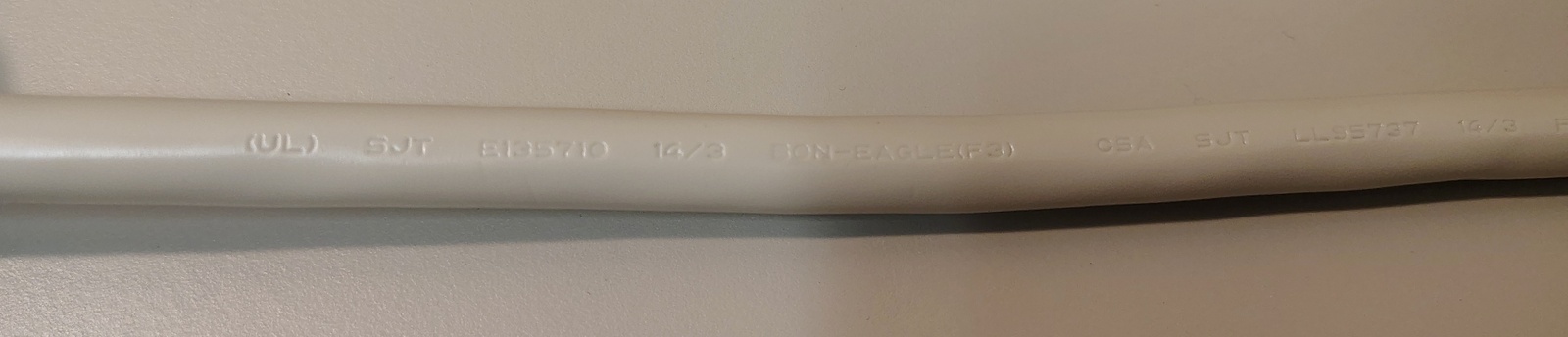 Power-cord markings showing SJT construction, UL and CSA approvals, and manufacturer information.