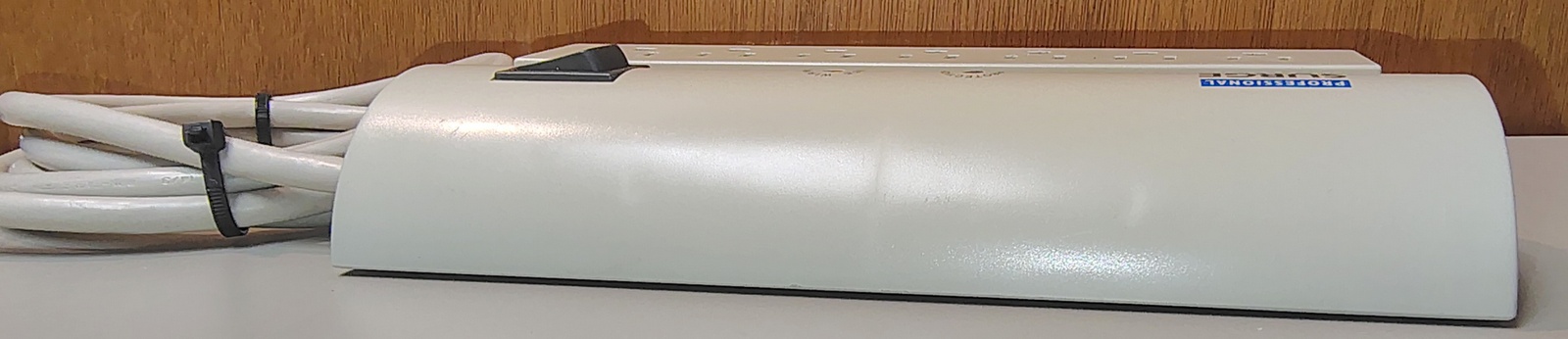 Opposite-side profile showing the rounded upper housing and power-cord routing.
