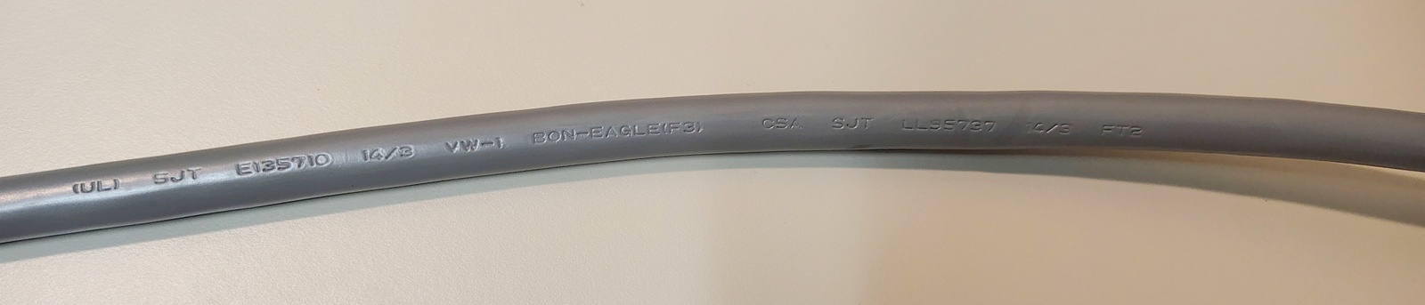 Power cord markings showing SJT construction, 14 AWG conductors, and approval information.