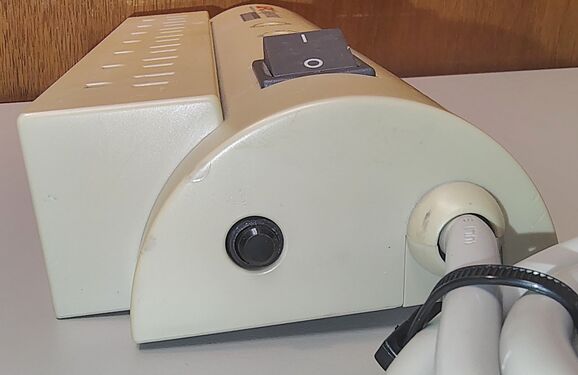 Cord-entry end showing the rocker switch, attached power cord, and overall enclosure design.