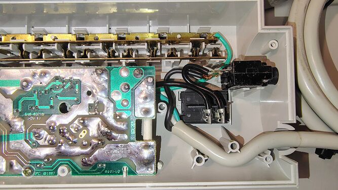 Cord-entry section showing switch assembly, circuit-breaker connections, grounding conductors, and PCB wiring.
