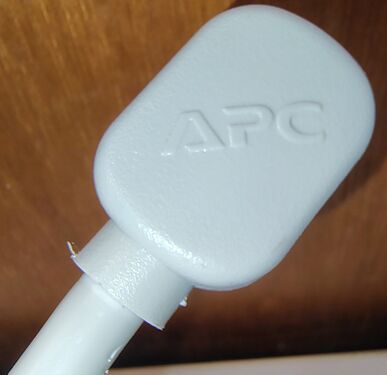 APC branding molded into the rear of the right-angle attachment plug.