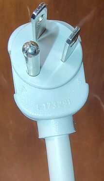 Close-up of the right-angle grounded attachment plug.