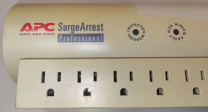 APC branding, status indicators, outlet section, and pronounced color difference between the exposed enclosure surface and the area previously covered by a label.