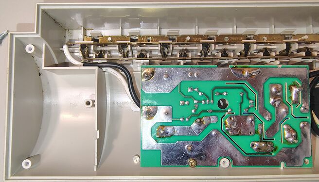 Outlet-contact assemblies, brass bus bars, and underside of the suppression circuit board.