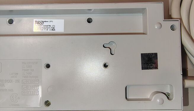 Right-side underside detail showing mounting provisions, serial-number label, and UL listing label.