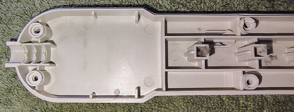 Interior view of the upper enclosure half showing the cord-entry area and outlet supports.