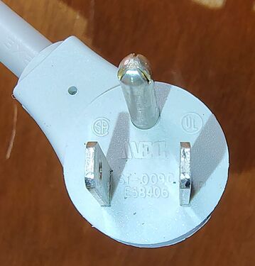 Attachment plug showing blade arrangement and certification markings.
