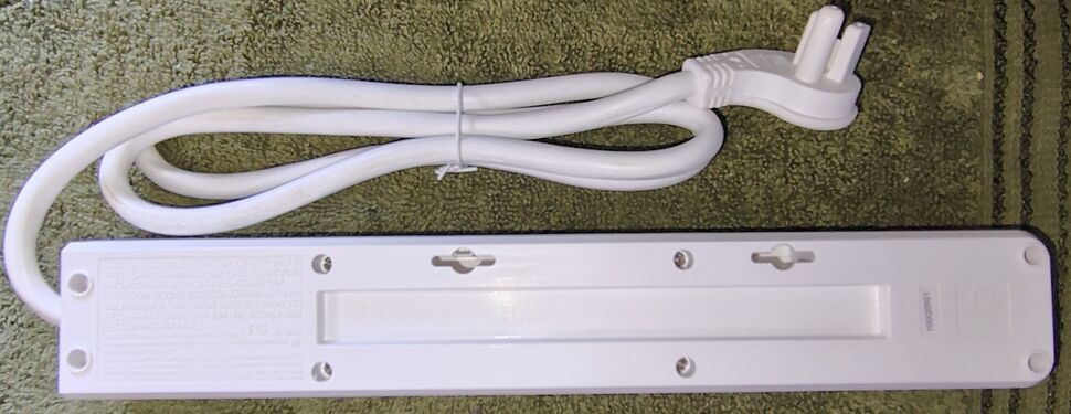 Underside view showing mounting provisions, labels, and electrical information.