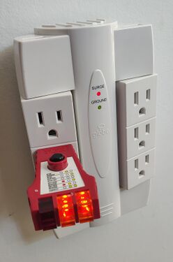 Receptacle tester indicating correct wiring and grounding.