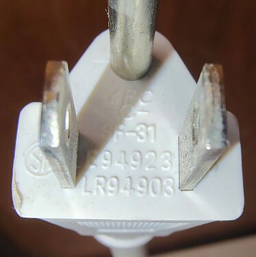 Grounding plug with certification markings.