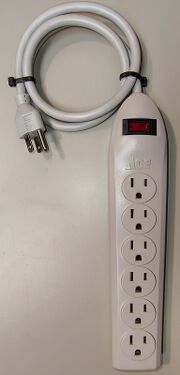 Overall view showing the six-outlet configuration, illuminated power switch, and attached power cord.