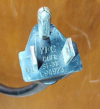 Close-up of the molded NEMA 5-15P plug assembly.