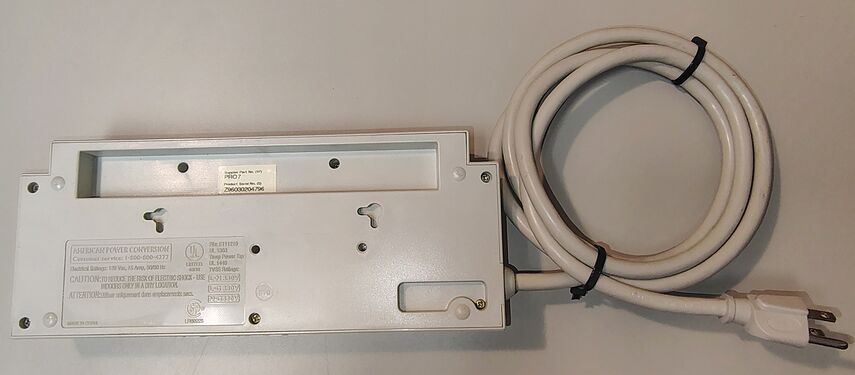 Underside overview showing mounting provisions, serial-number label, and regulatory markings.