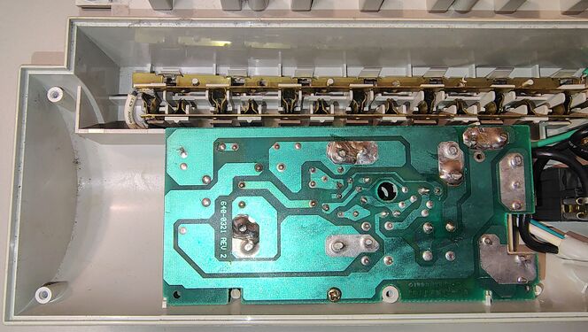 Left side of the lower enclosure showing the suppression board, brass outlet-contact strips, and internal layout.