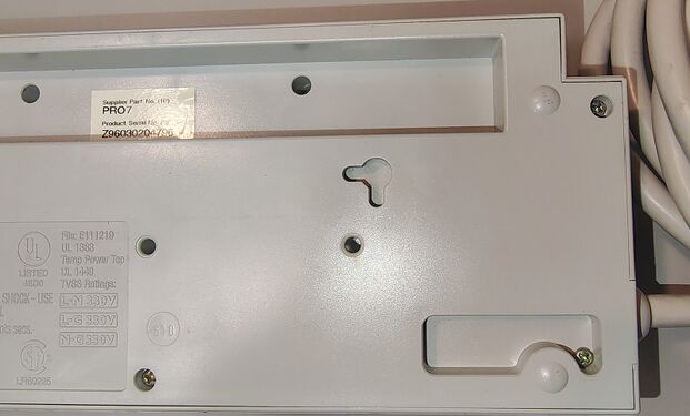 Cord-entry end showing power-cord strain relief and enclosure details.