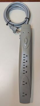 Overall view of the documented PowerSentry Model 626 showing the elongated enclosure, seven grounded outlets, and integrated cord-management features.
