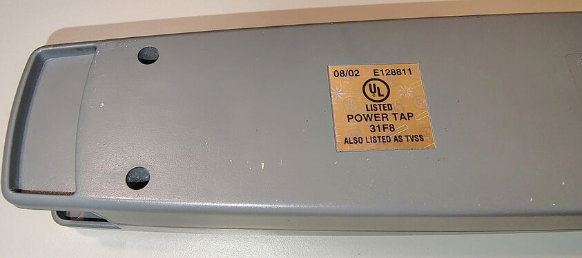 UL listing label showing 08/02 date marking and UL file number E128811.