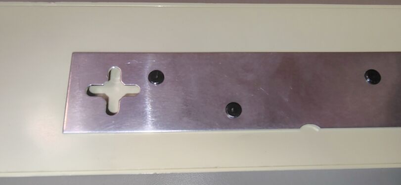 Stamped keyhole slot in the underside mounting plate.