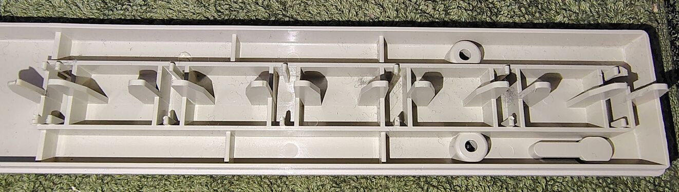 Interior of the upper enclosure showing outlet guides and structural reinforcements.