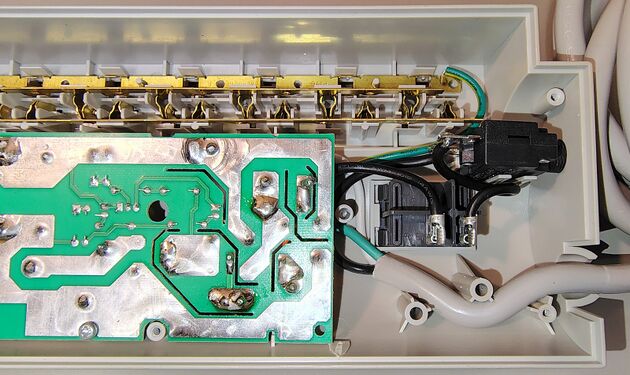 Cord-entry section showing the power switch, circuit breaker, wiring, and circuit board.