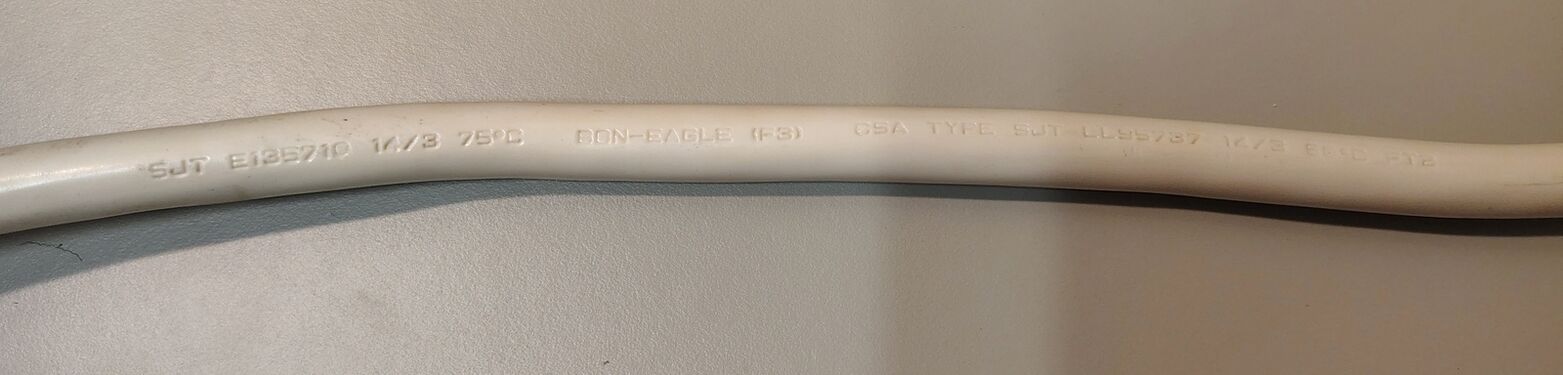 Power-cord markings showing SJT construction, conductor size, and manufacturer information.