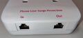 Integrated RJ11 telephone line surge protection ports.