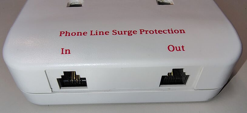 Integrated RJ11 telephone line surge protection ports.