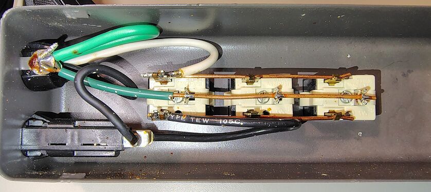 Circuit breaker, cord termination, and copper bus conductors.