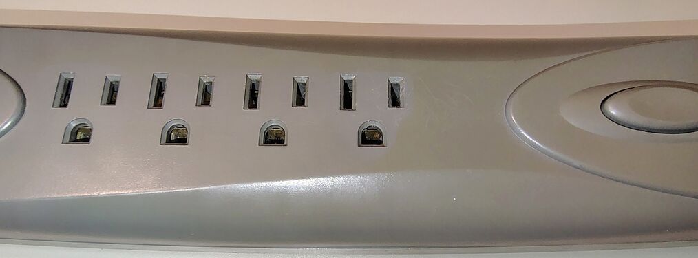 Outlet detail showing the seven grounded receptacles and tapered enclosure profile.