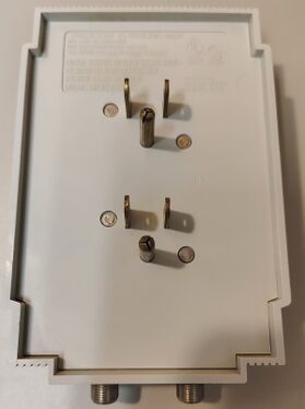 Rear view showing dual-plug mounting arrangement and riveted enclosure construction.