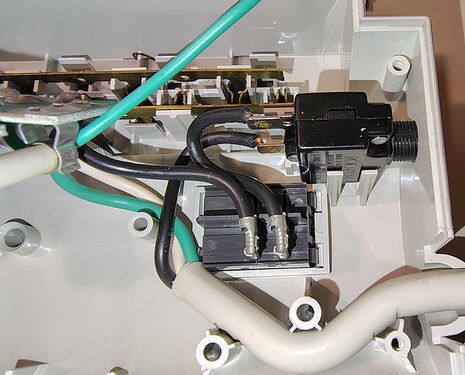 Power-cord termination, rocker-switch assembly, and resettable circuit-breaker wiring.
