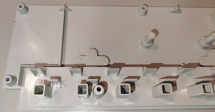 Upper enclosure details showing molded outlet barriers and structural reinforcement features.