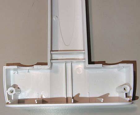 Lower housing structural details and screw bosses.