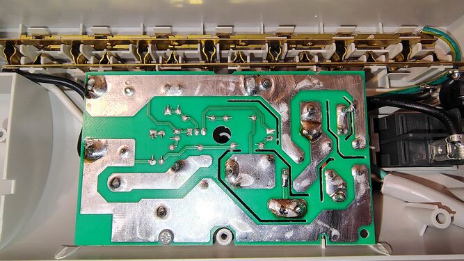 Underside of the surge-suppression circuit board showing copper power traces and solder connections.