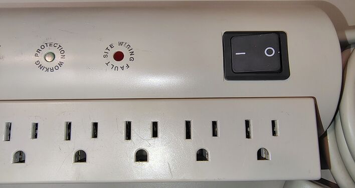 Rocker switch, status indicators, and outlet section.