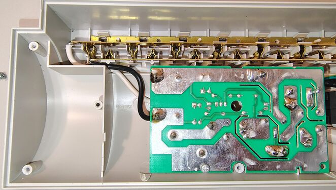Left-side interior overview showing the outlet-contact assembly and surge-suppression board.