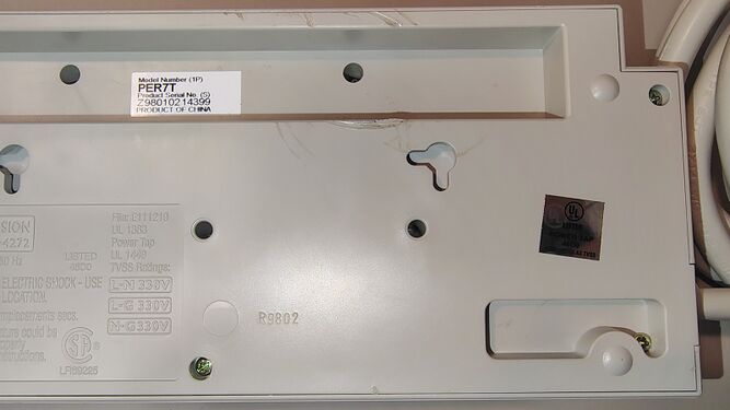 Cord-entry underside detail showing the serial-number label, mounting provisions, and UL hologram label.