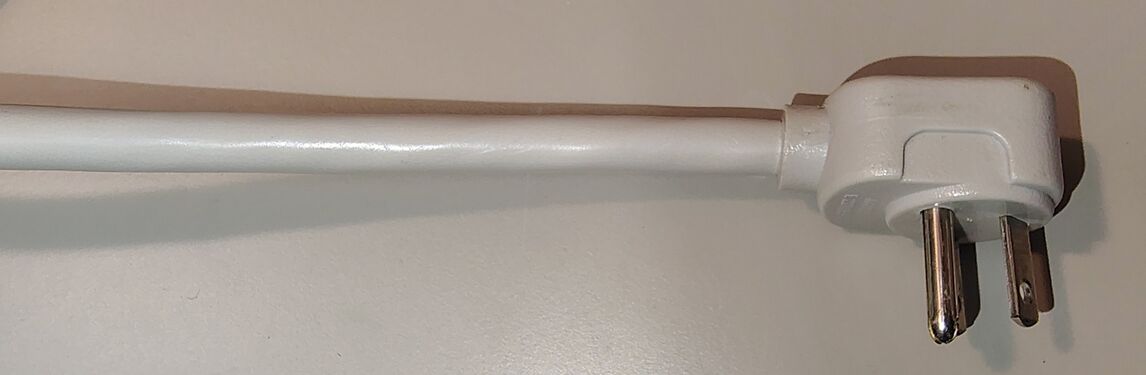 APC-branded right-angle attachment plug and attached power cord.
