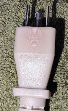 Attachment plug showing molded COXOC branding.