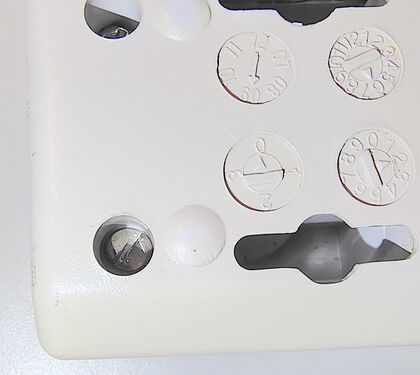 Close-up view of a one-way security screw used to discourage disassembly.