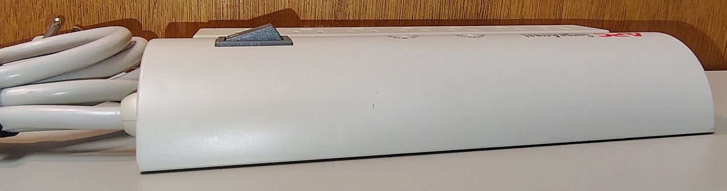 Opposite side profile showing the enclosure shape and attached six-foot power cord.