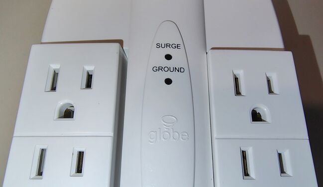 Close-up of the central section showing SURGE and GROUND status indicators together with molded Globe Electric branding.