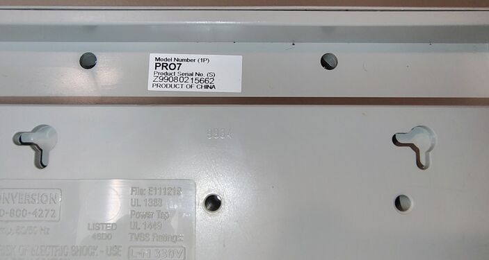Serial-number label identifying the documented APC PRO7 example and adjacent molded enclosure markings.